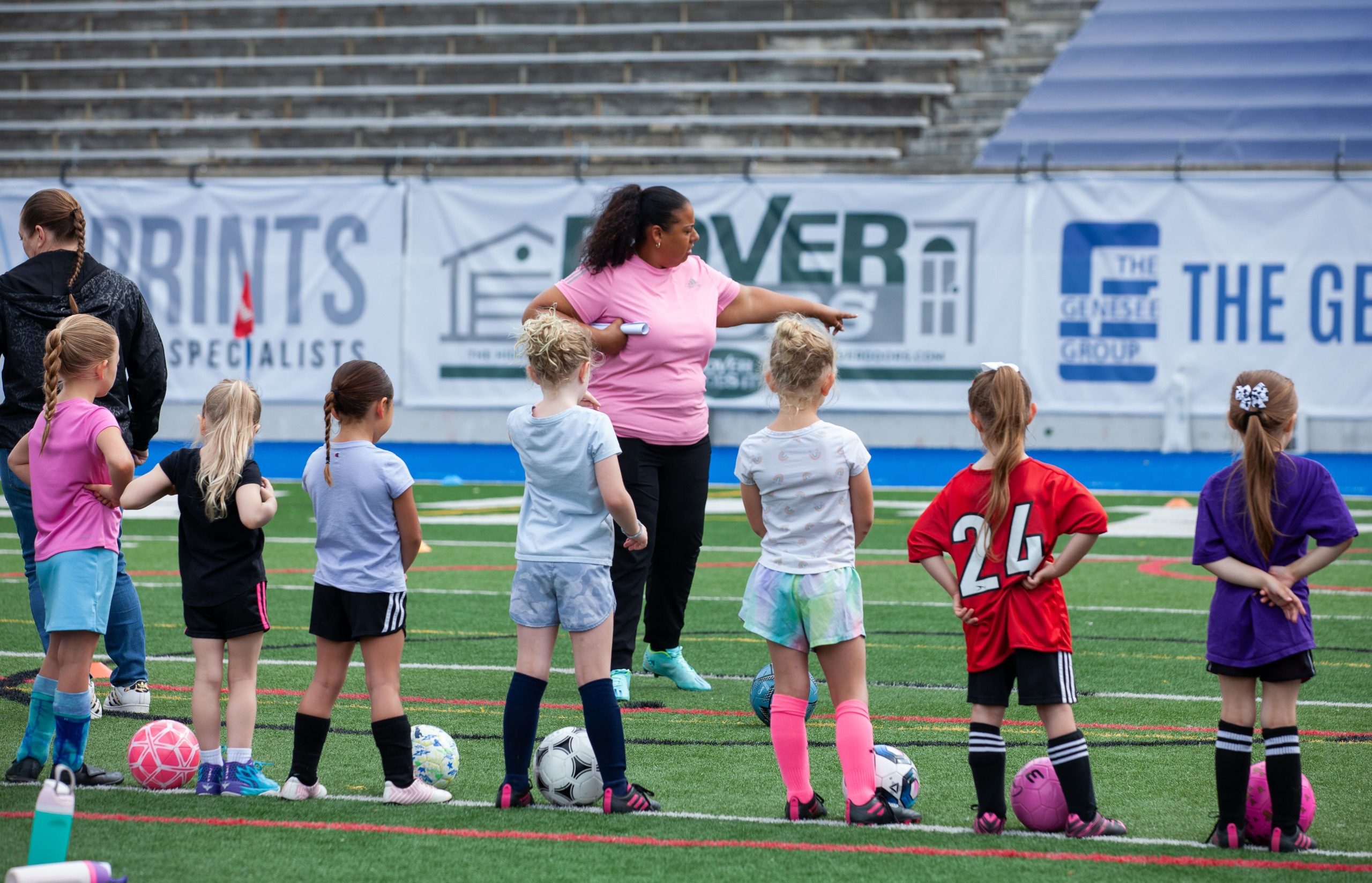 Young participants listen to instructions during the 'Empowering Women in Soccer Flint Style!' clinic at Atwood Stadium on Saturday, June 8, 2025.