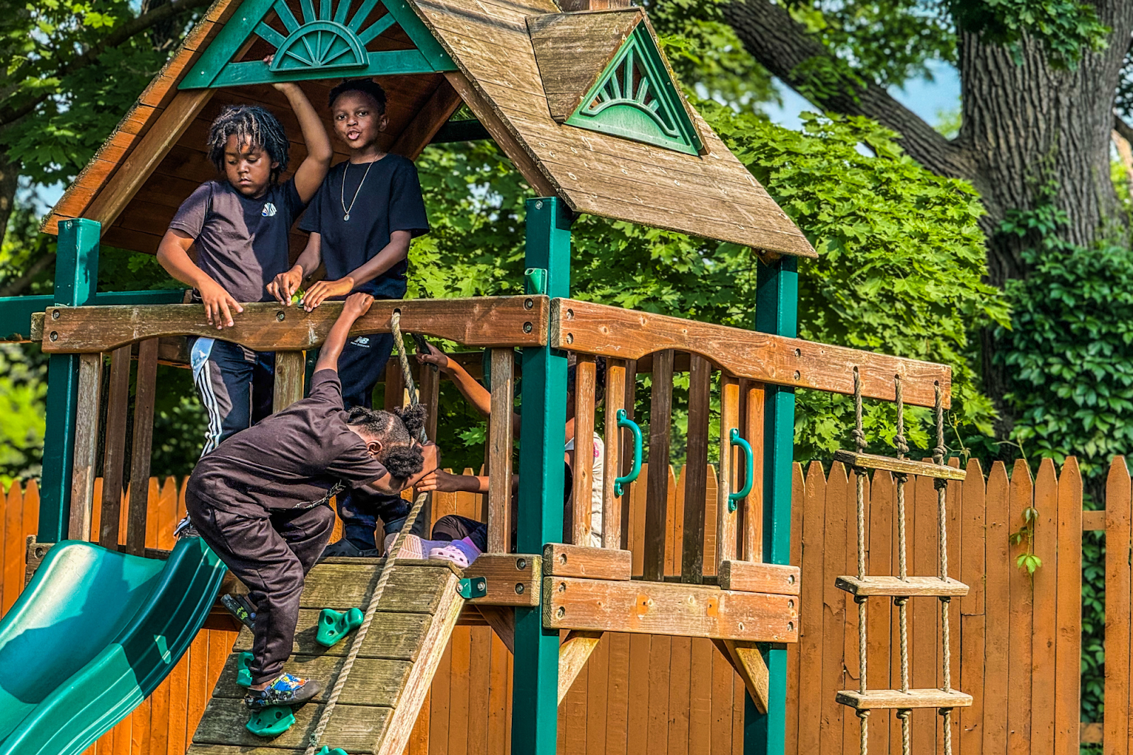Children play on the slide and swingset at the Juneteenth festival on June 8, 2025.