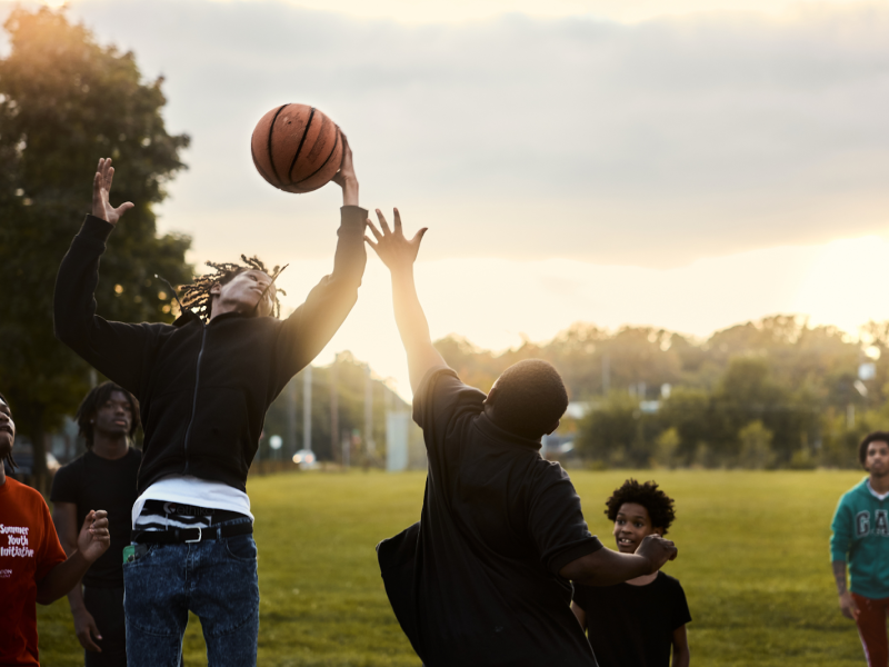 Neighborhood kids enjoy an evening game of basketball.