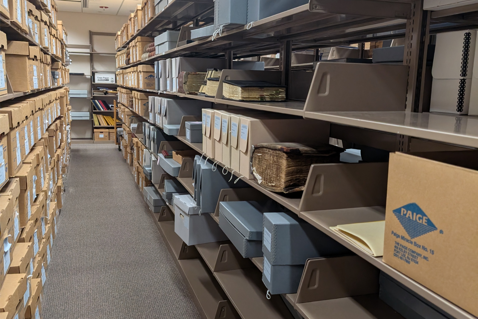Boxes line the shelves at the GHCC inside UM-Flint's library.