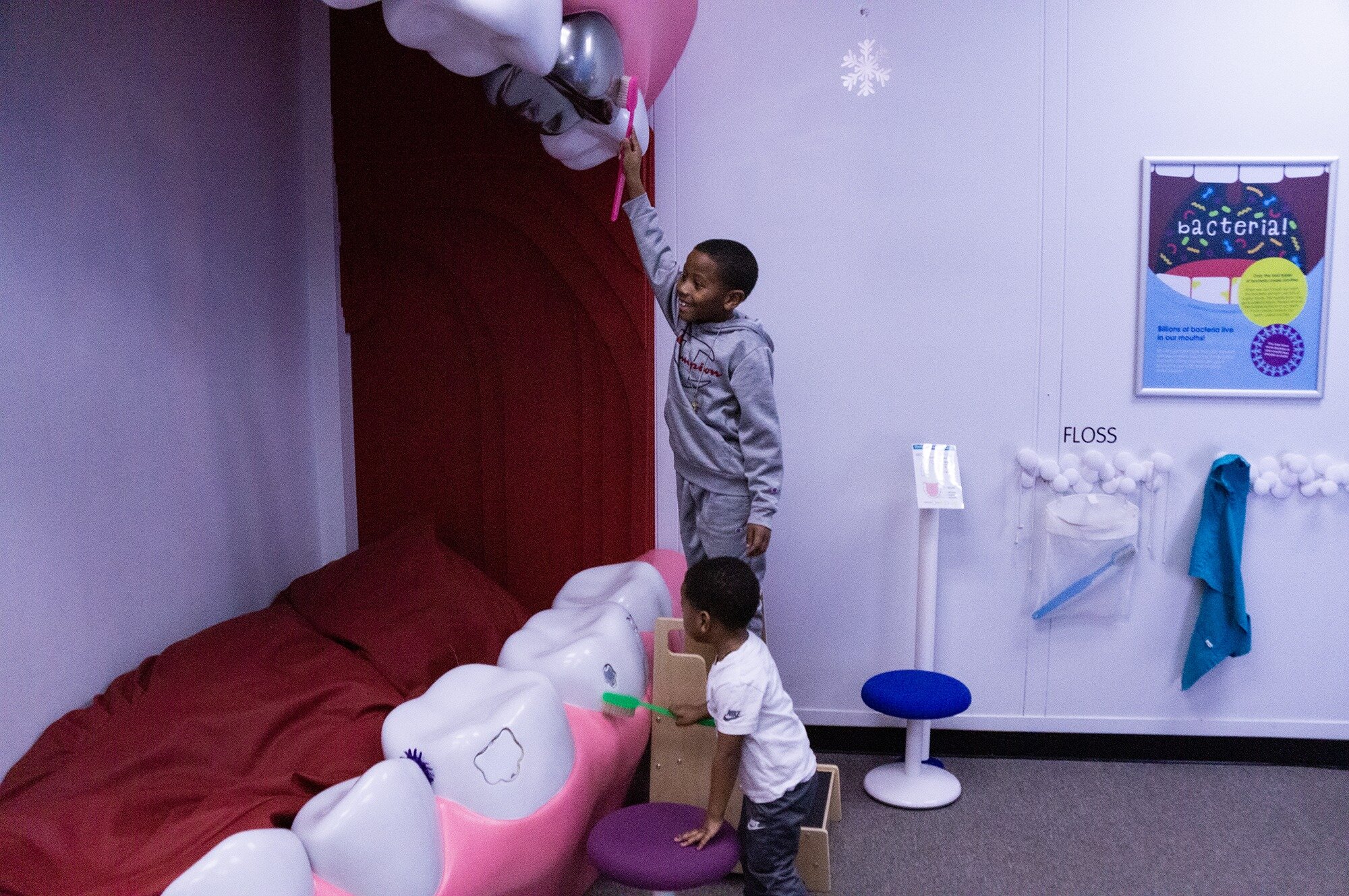 Young boys play in the Future Dentists area at the Flint Children’s Museum.