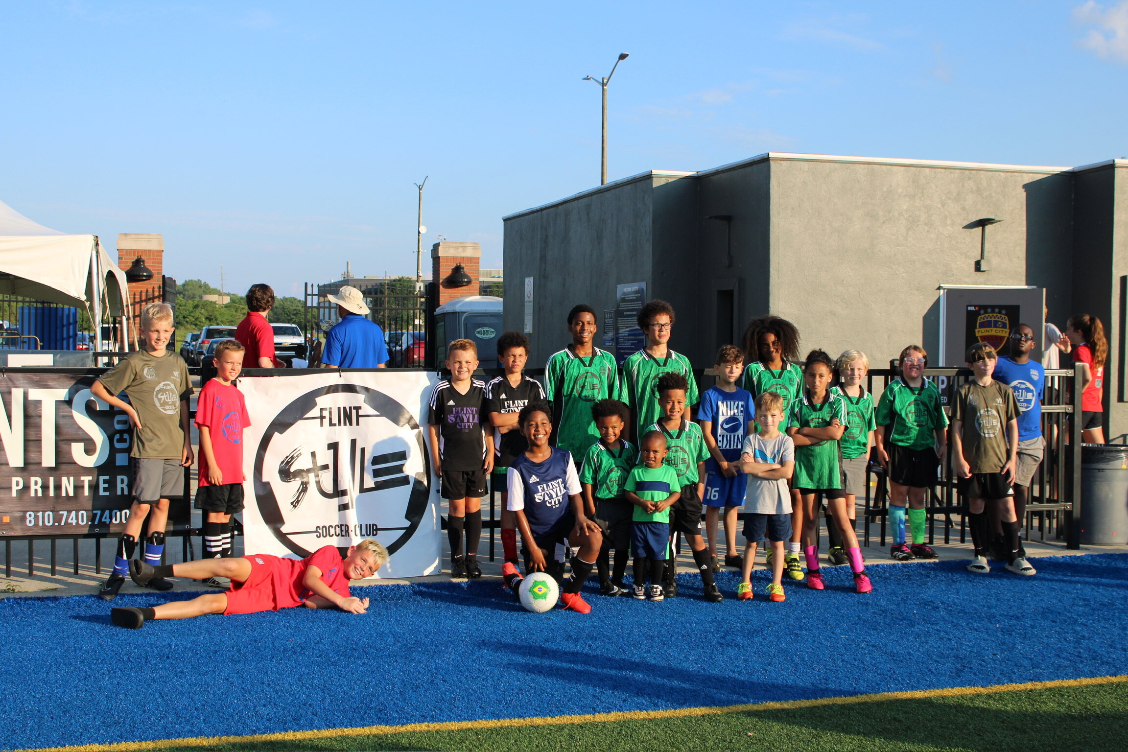 The kids of Flint Style Soccer pose for a group photo. (Photo credit: Susan Lanstra)