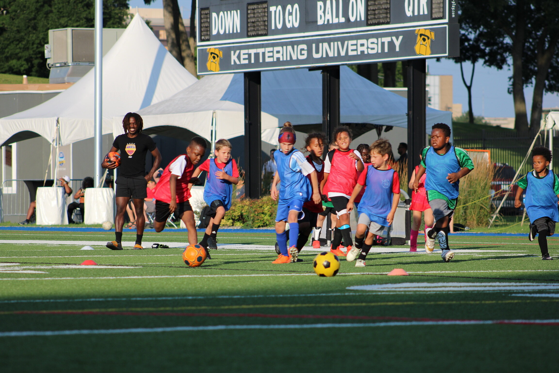 The kids of Flint Style Soccer practice on the field. (Photo credit: Susan Lanstra)