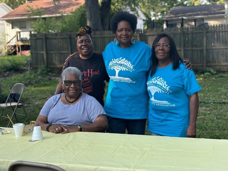 Flint native Jeanette Edwards stands in the middle and smiles with fellow Brownell-Holmes community members on Sept. 12, 2024.