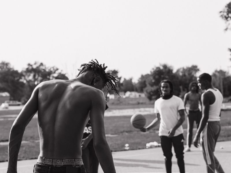 A group of young men pass the time playing basketball in the Brownell-Holmes area, pictured on Sept. 15, 2024.