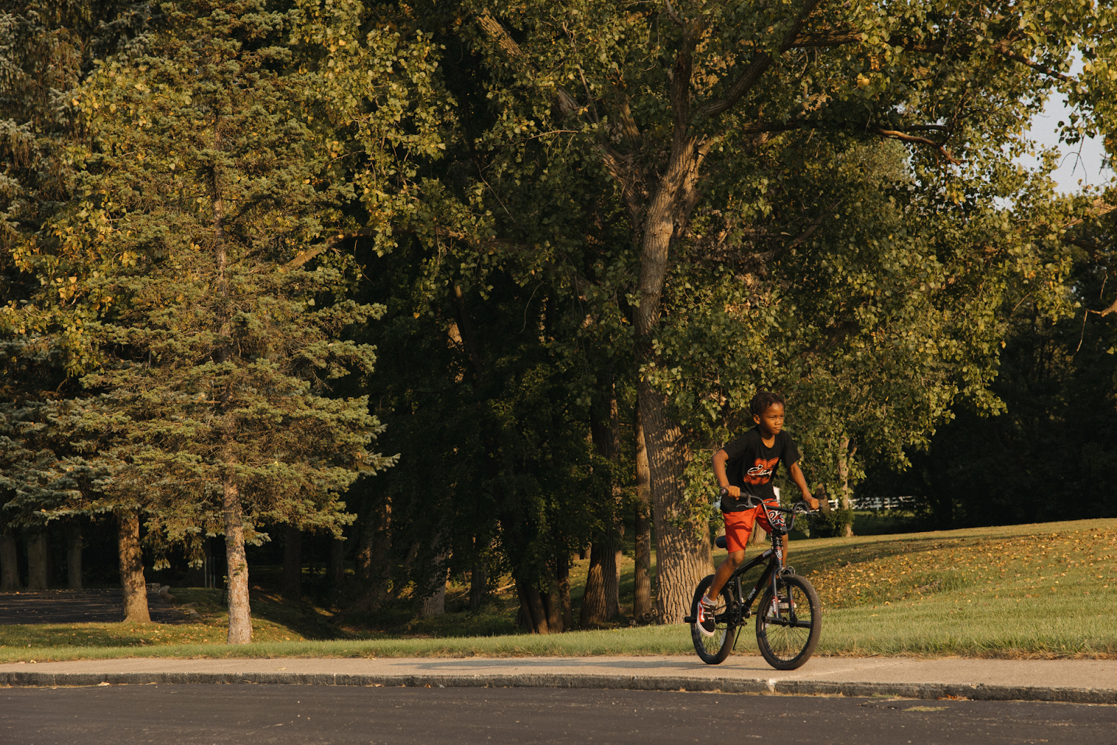 A boy rides his bike during sunset on Sept. 15, 2024. (Anthony Summers | Flintside.com)