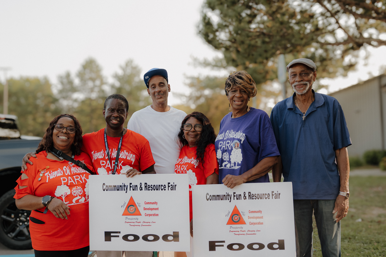 The Friends of Hasselbring Park pose for a portrait while serving food to residents at Hasselbring Senior Community Center on Sept. 14, 2024. (Anthony Summers | Flintside.com)