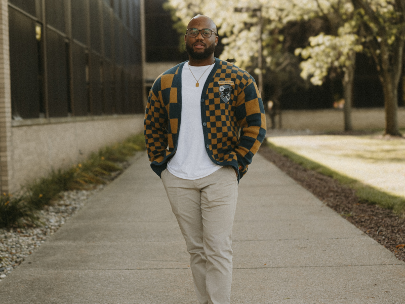 Art teacher and founder of Artxtension: Education-Equity-Empowerment, Jordan Barnett, poses confidently outside Mott Middle College on September 10, 2024.