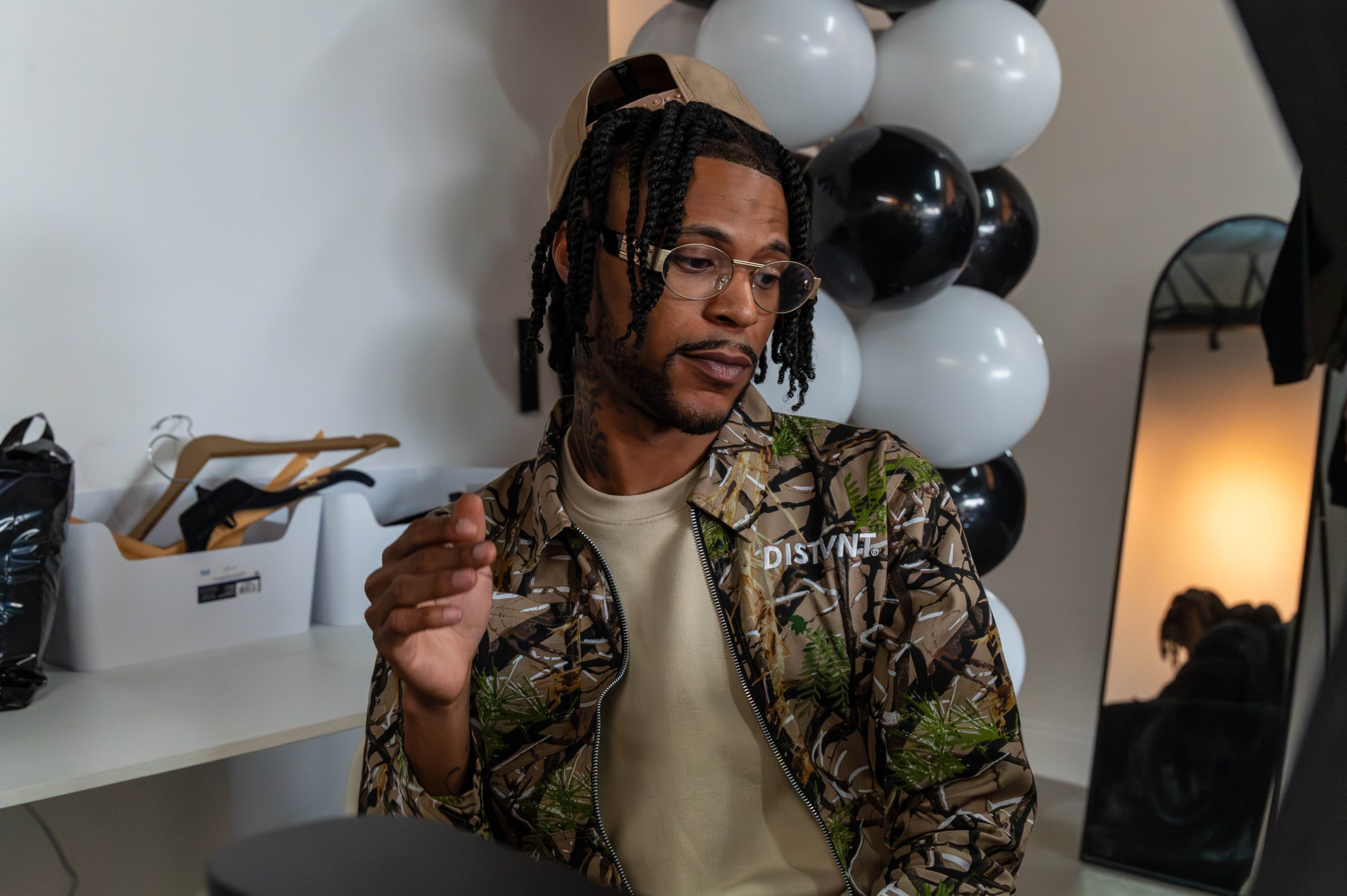 Jock Giles wears one of DISTVNT's new Fall collection releases during the grand opening of DISTVNT's storefront on Saturday, September 7, 2024. (Ray Gray | Flintside.com)