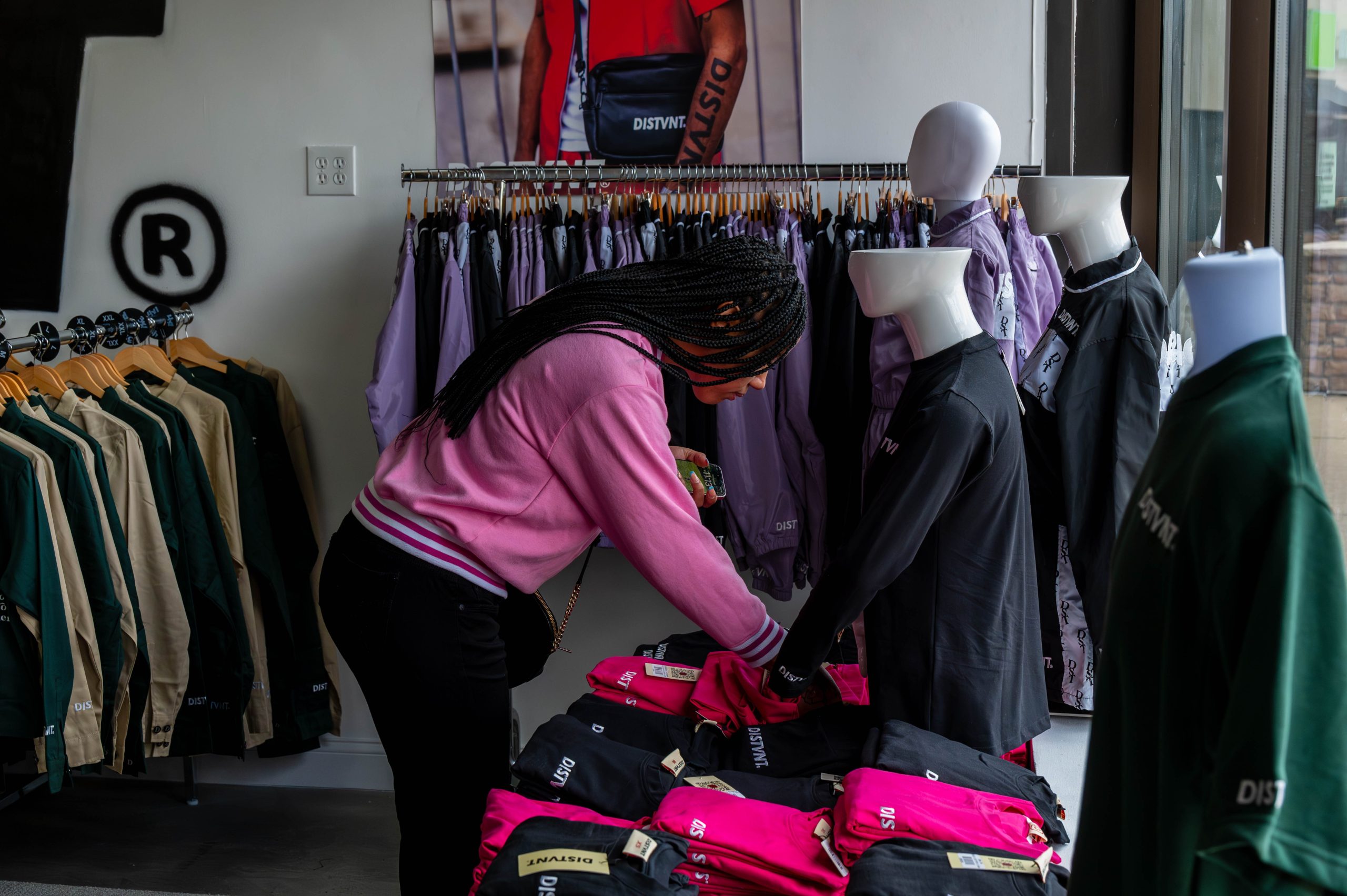 A customer shops during the grand opening of DISTVNT's storefront on Saturday, September 7, 2024. (Ray Gray | Flintside.com)