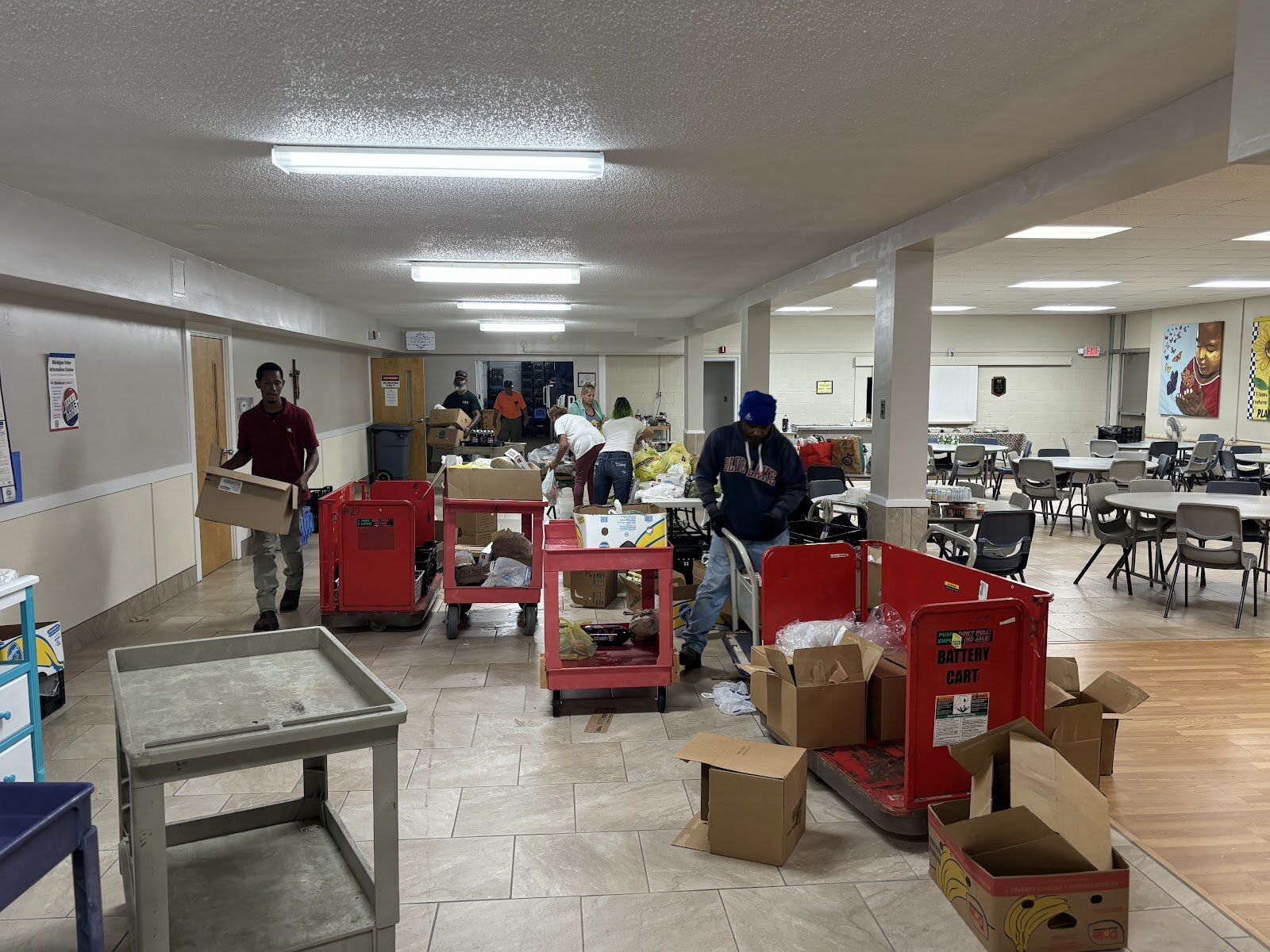 Staff and volunteers work during St. Luke's weekly food giveaway on Aug. 16, 2024. (Jerimiah Whitehead | Flintside.com)