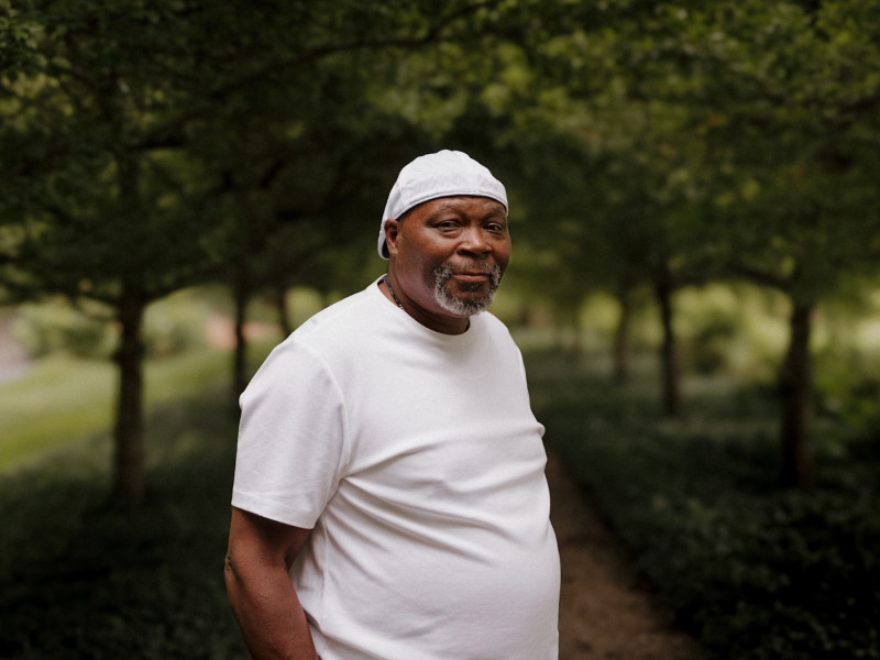 Pictured on a walking path at Applewood Estates on August 11, 2024, former City of Flint police officer Ronnie Summers stands proud of his achievements.