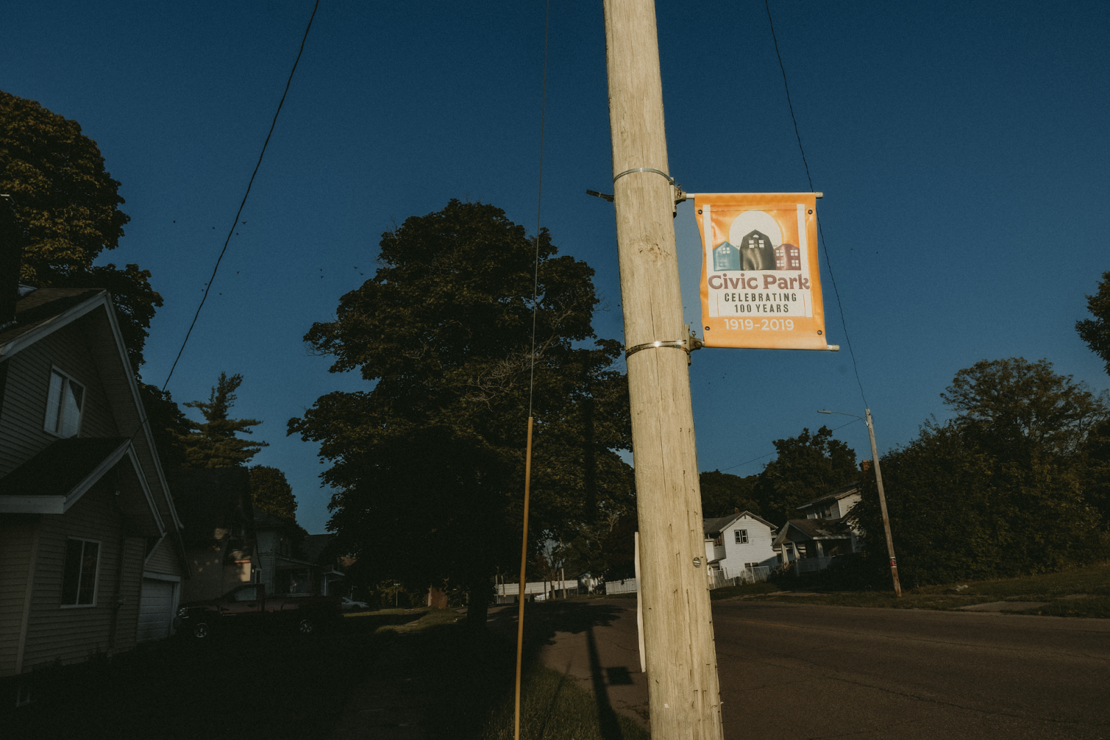 Pictured on Aug. 12, 2024, flags welcome everyone to the Civic Park Neighborhood which celebrated its centennial in 2019. (Anthony Summers | Flintside.com)