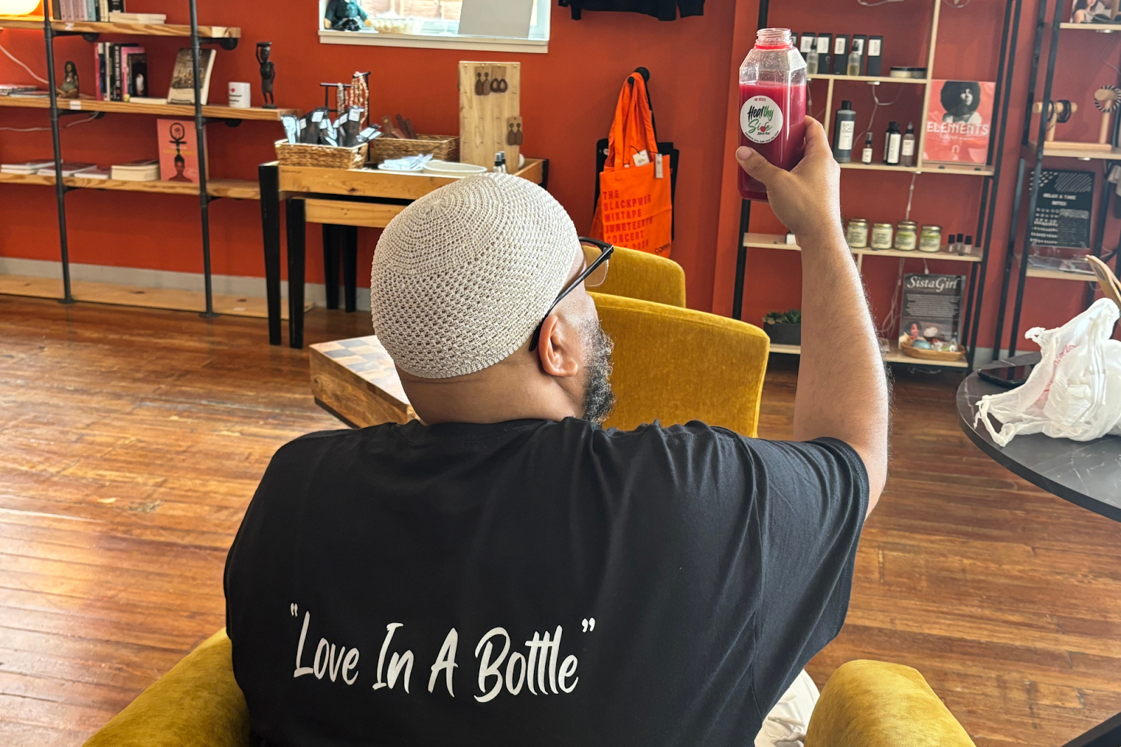 Sa’eed Littlejohn toasts to good health with one of his fresh juices from Healthy Side. (Jerimiah Whitehead | Flintside.com)