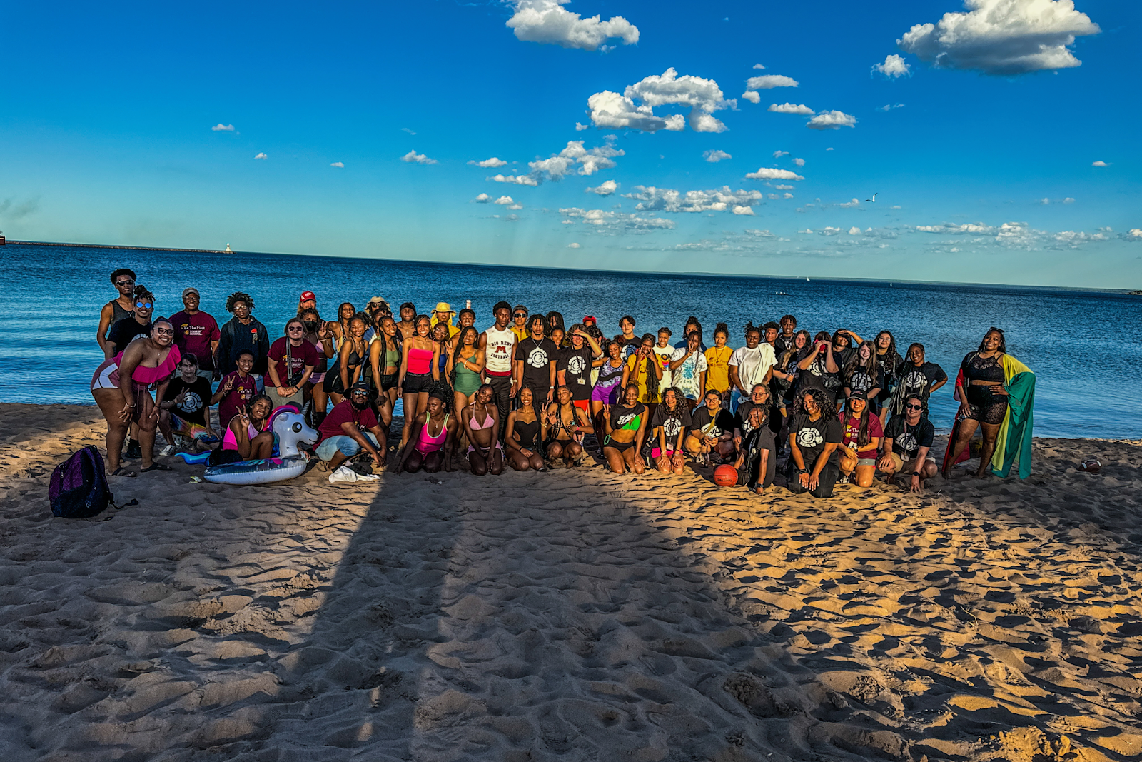 CMU and FSU GEAR UP students and staff pose for a group photo at Clark Lambros Beach in Marquette, MI, on June 25, 2024. (Xzavier Simon | Flintside.com)