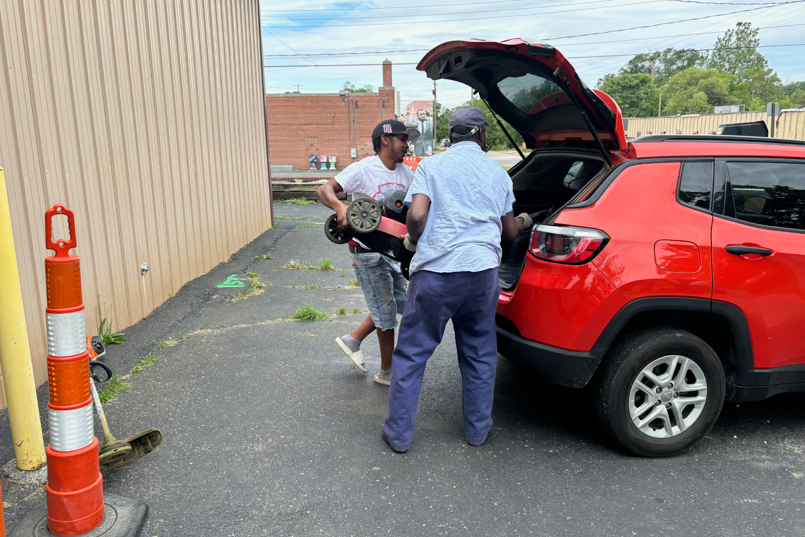 "My girl is always happy when she sees me bring home this lawnmower," says a community member utilizing the NEH's free services. (Jerimiah Whitehead | Flintside.com)