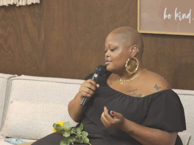 Flint native AshleyCae Lee sits and recites a poem at her fundraising event on Saturday, June 22, 2024.