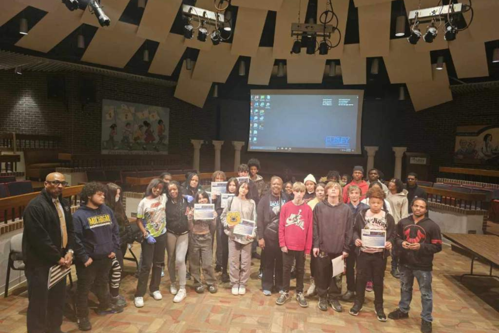 Students pose with Hurley Hospital's Jamal Dozier after a certificate ceremony inside Hurley Auditorium on April 19, 2024. (Courtesy photo)