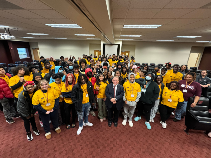 GEAR UP students from the International Academy of Flint and Flint Southwestern Classical Academy pose inside Central Michigan University's IAC with President Davies and Howard University Alternative Spring Break students on March 8, 2024.