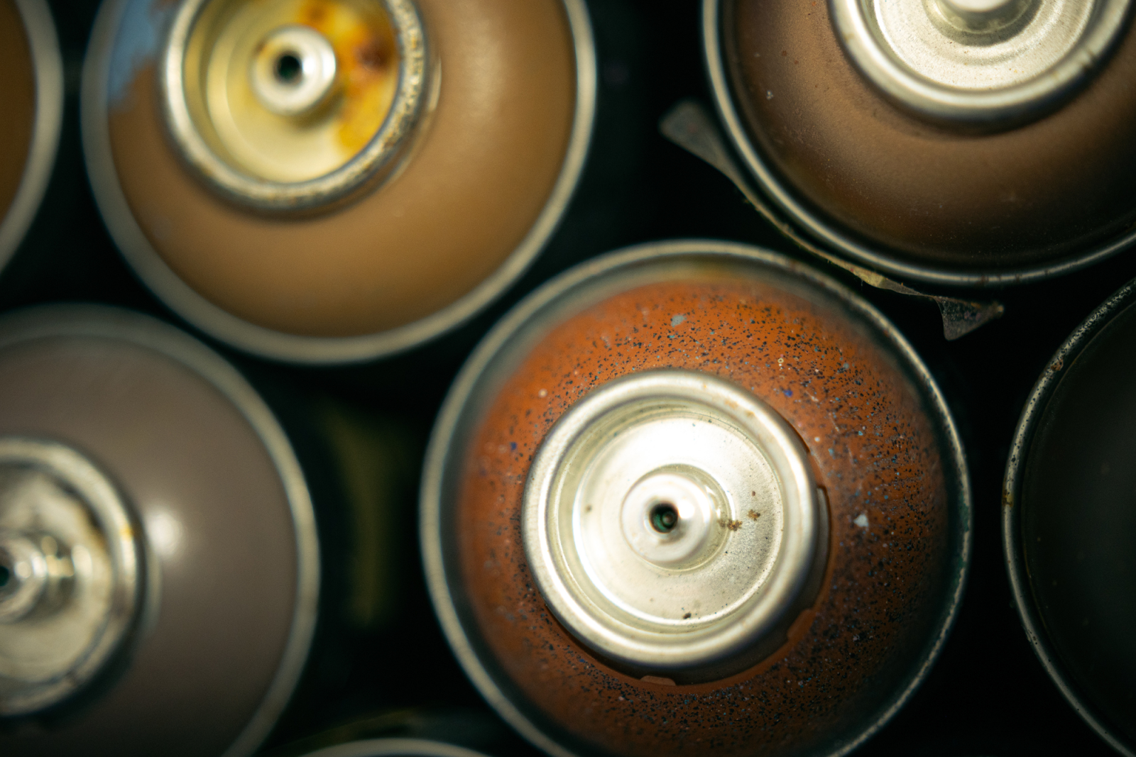 Pictured on Jan. 29, 2024, spray paint cans, tools, chairs, tables, and more create a creative atmosphere of freedom inside Lovett's studio. (Anthony Summers | Flintside.com)