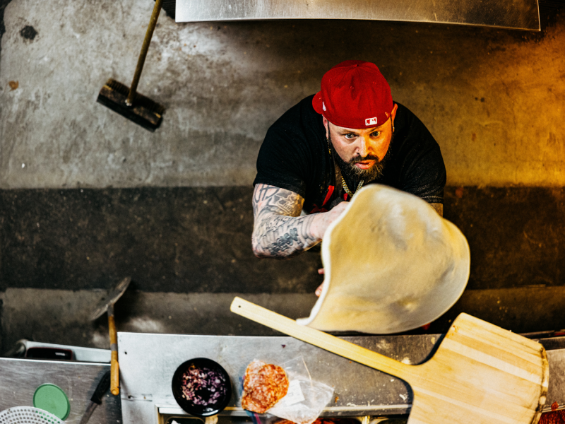 Bada Bing Pizzeria's owner and head chef Anthony Ijames pictured on Jan. 18, 2024, spinning their signature pie, Little Italy.