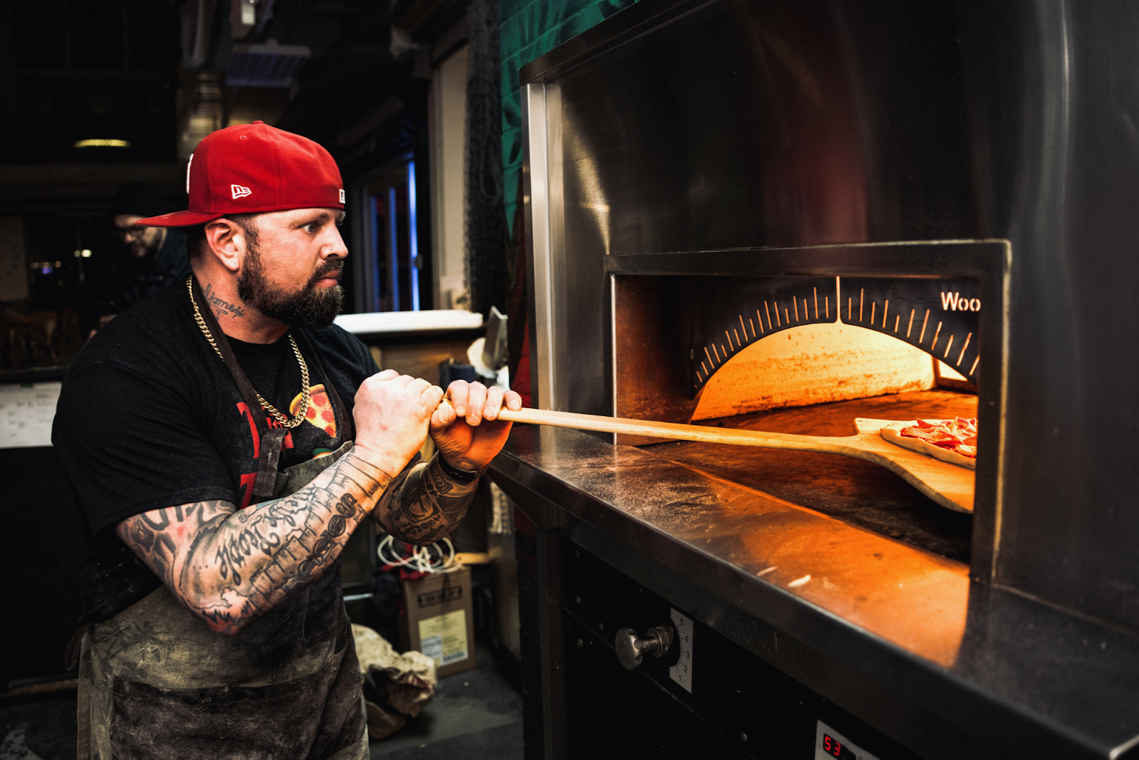 Pictured on Jan. 18, 2024, Ijames works diligently to ensure every Bada Bing handmade and crafted pizza is in top order. (Bryce Mata | Flintside.com)