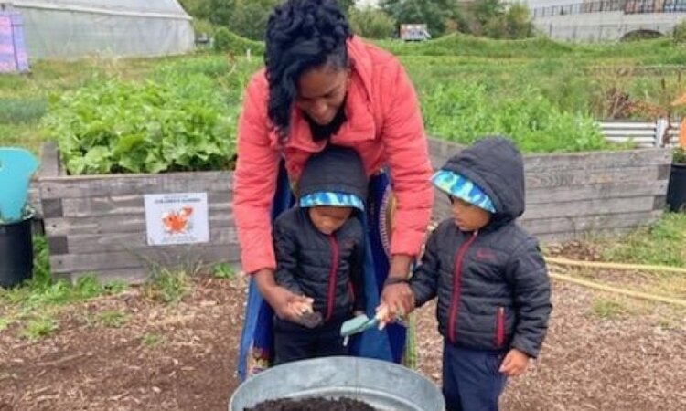 Lorna Parks, owner of House of Joy Childcare in Detroit, tours the Keep Growing Detroit Garden.