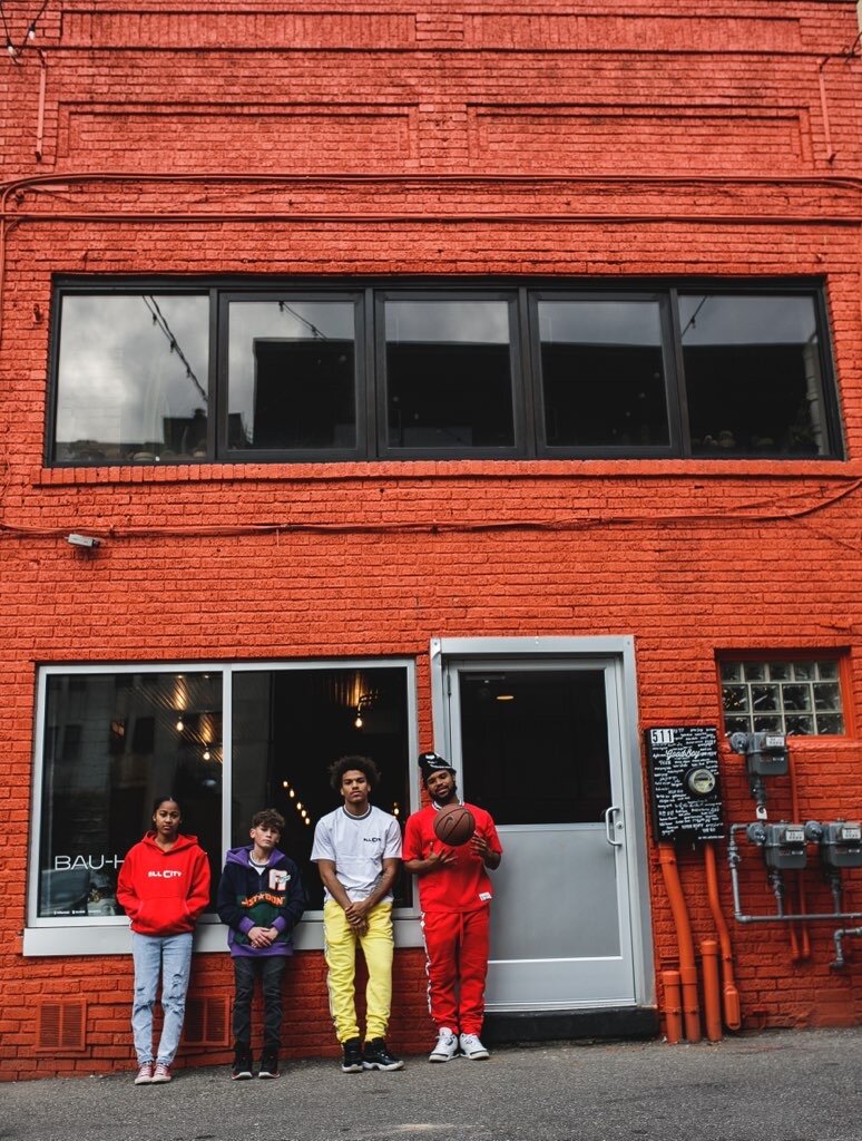 Young models pose during a photoshoot in front of BAU-HOUSE located in downtown Flint.