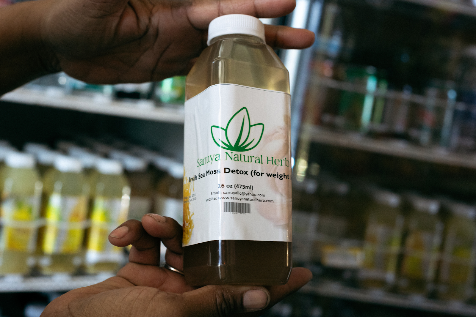 Sanuya Natural Herb's Irish Sea Moss Detox, hibiscus, and ginger drinks stocked in a refrigerator inside BAMS African Market photographed on Dec. 20, 2023. (Anthony Summers | Flintside.com)