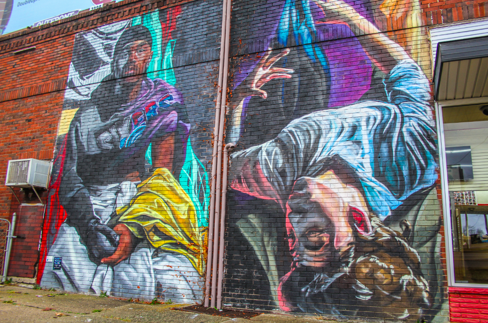 Pictured on Dec. 27, 2023, one of the Flint Mural Plays murals stands proudly on display outside Courtside Cuts on the corner of Flushing Rd. and N. Chevrolet Ave. (Xzavier Simon | Flintside.com)