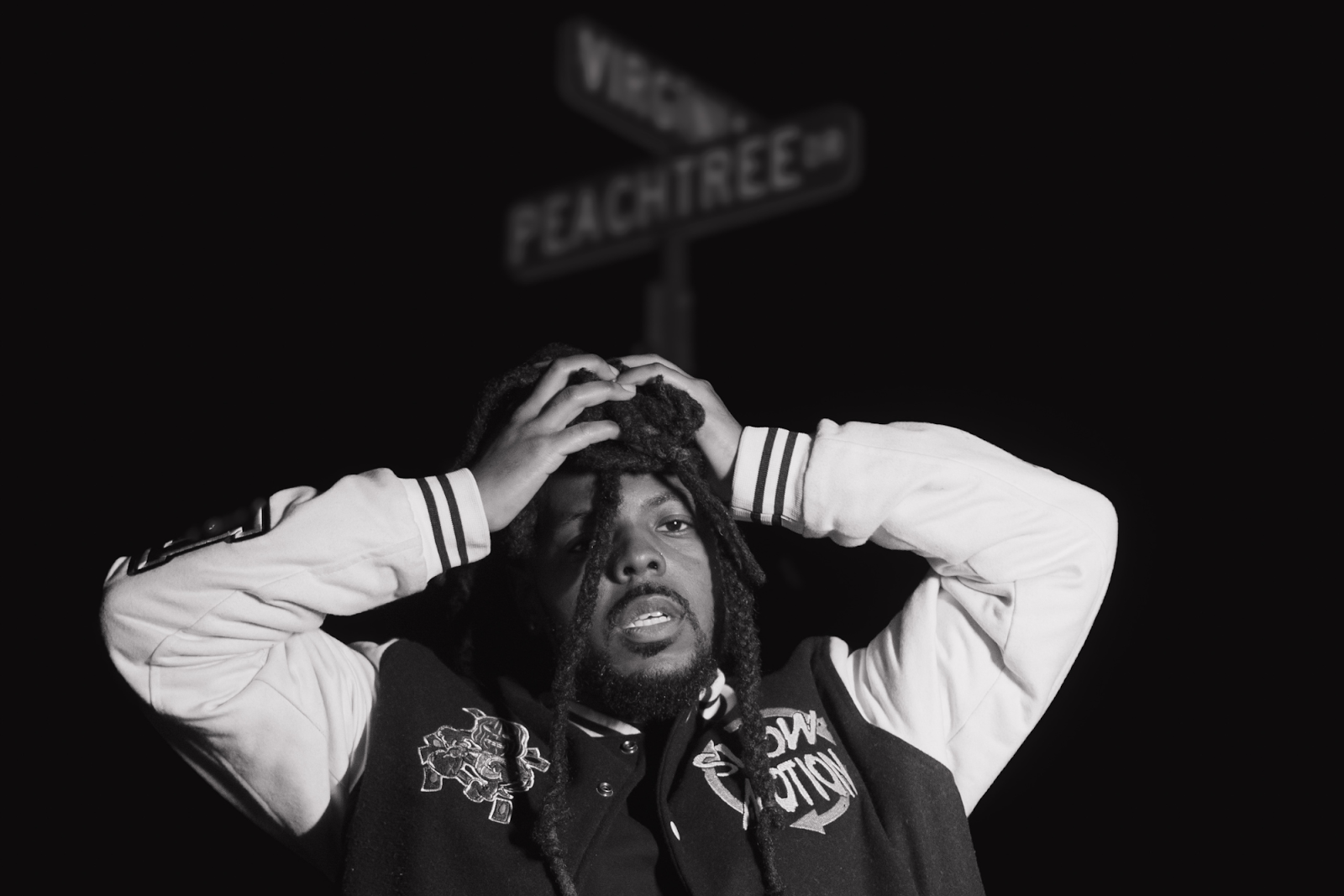 "'Azure' kind of goes into this whole space of me leaving the Earth," explains Wiley, pictured outside underneath the sign street on Nov. 30, 2023. (Anthony Summers | Flintside.com)