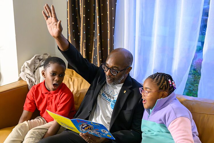 James Ribbron reads to Dwayne Sharpe and Elizabeth Brooks.
