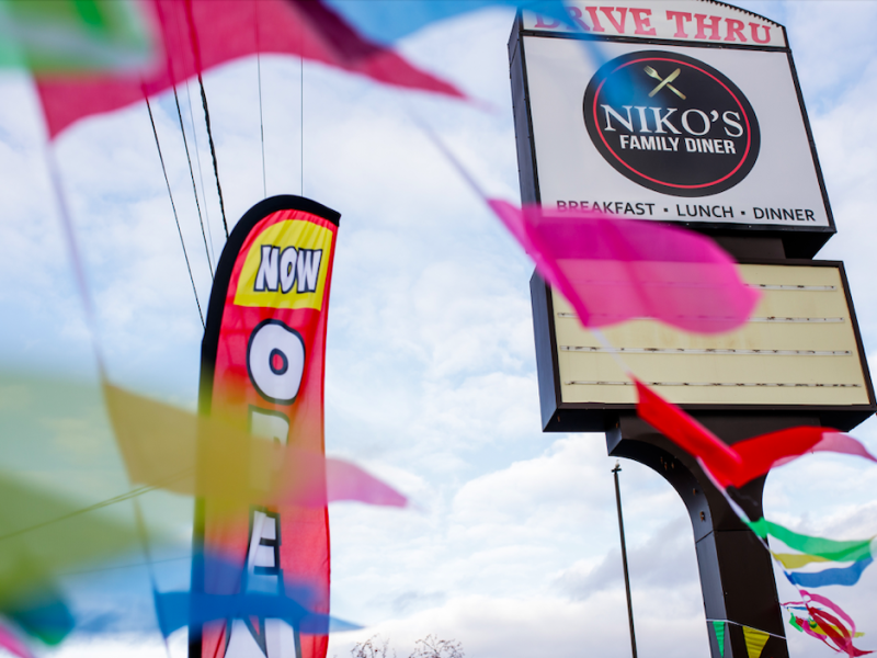 Niko’s Family Diner sign is decorated with “Now Open” banners to welcome new customers on November 22, 2023.