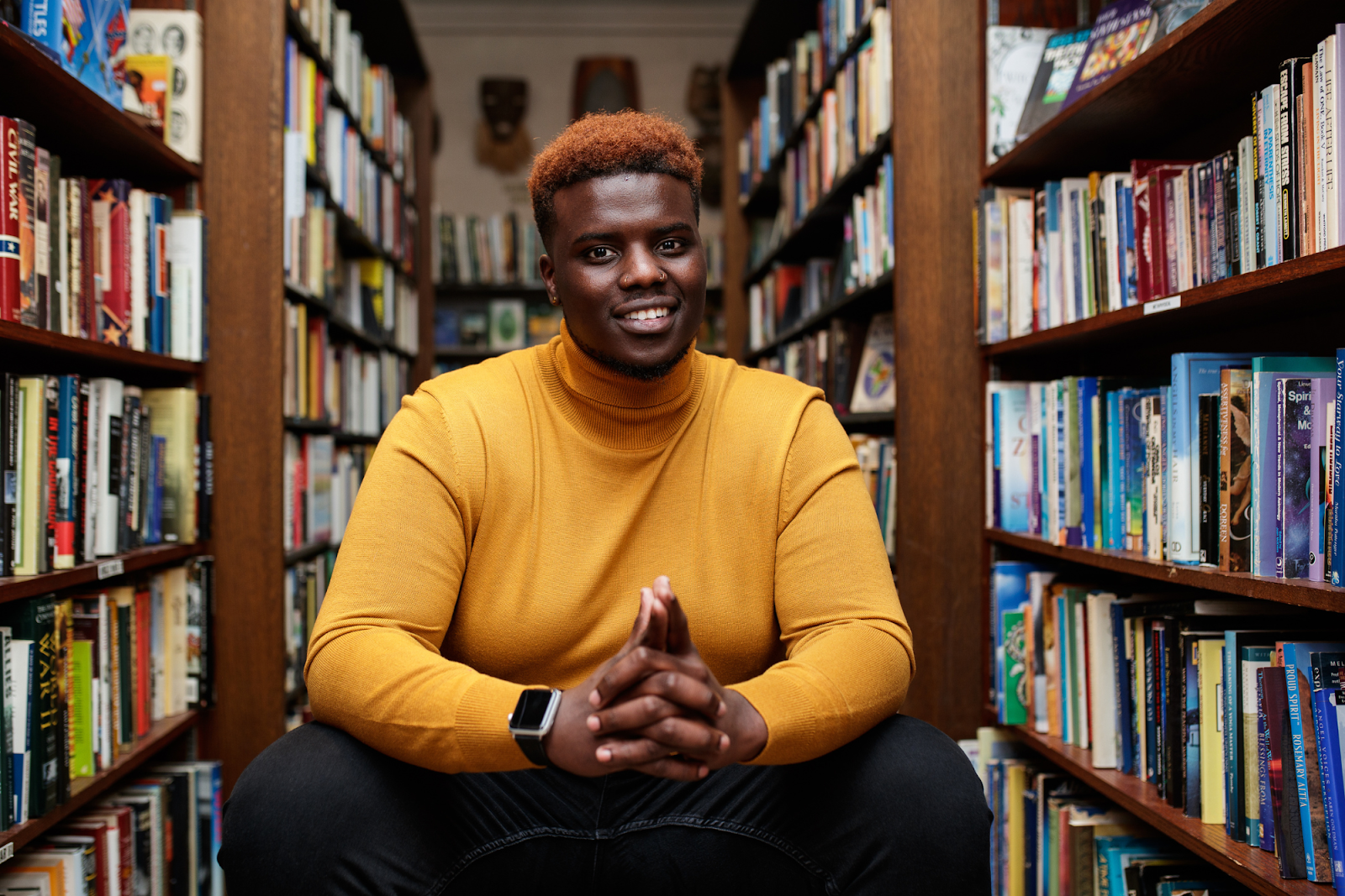 “I’m nobody’s victim. I am one of one. I know who I am now. I am happy," says Jerimiah Whitehead, smiling inside Totem Books on Nov. 17, 2023. (Jenifer Veloso | Flintside.com)