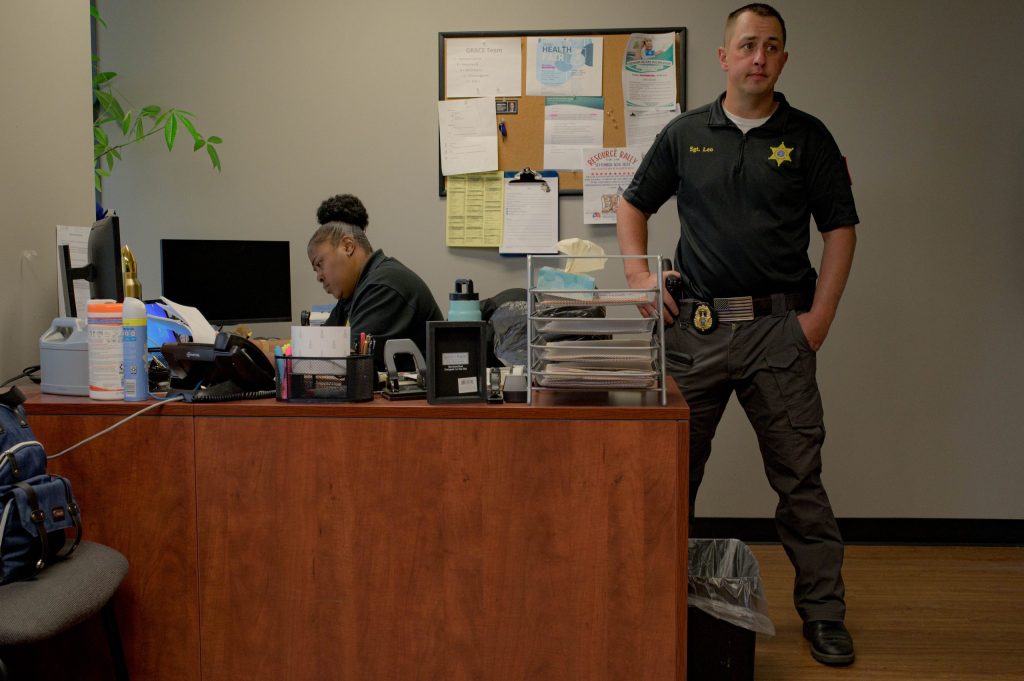 Sgt. Leonowicz (right) and Sgt. Reeves (left) start their day in the office of the GRACE Team, an initiative of the Genesee County Sheriff’s Office that supports victims of elder abuse, in downtown Flint, Mich. on Wednesday, Aug. 30, 2023. (Michael Indriolo | Flint Beat)
