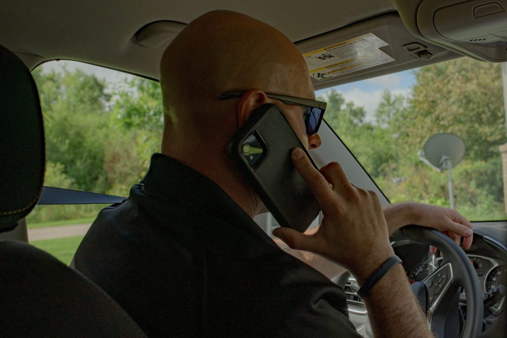 Genesee County Sheriff’s Deputy Christian Bowman, of the GRACE Team, makes a call on Wednesday, Aug. 30, 2023. (Michael Indriolo | Flint Beat)
