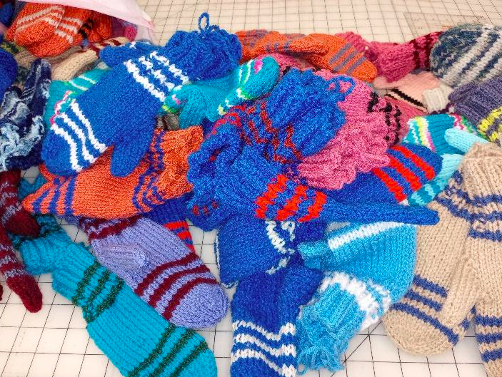 Hand-knit mittens await delivery to preschool and kindergarten classrooms. (Sherrema A. Oom-Dove | Flintside)

