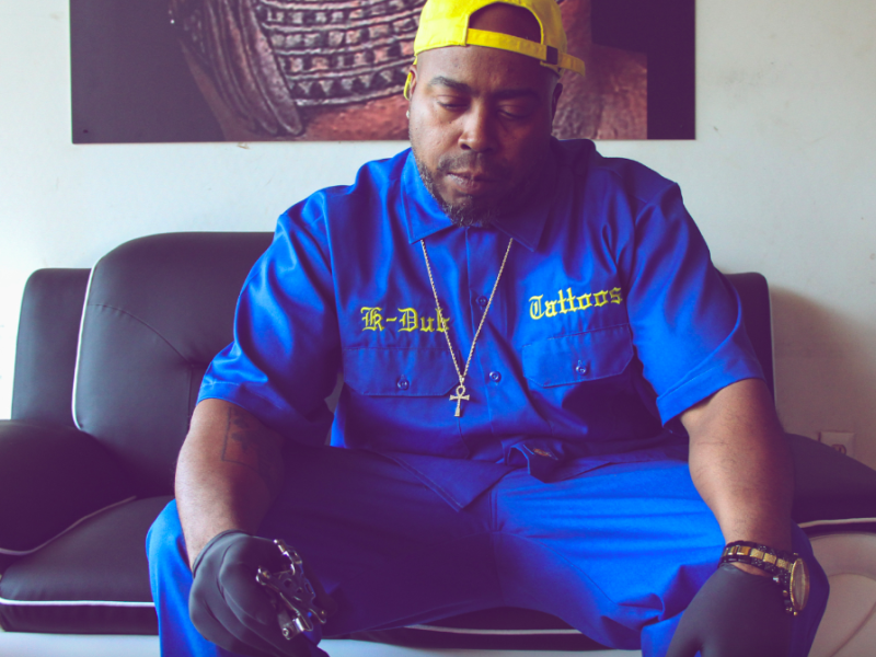 Flint native K-Dub sits inside his shop K-Dubs Tattoos on September 21, 2023. (Xzavier Simon | Flintside)