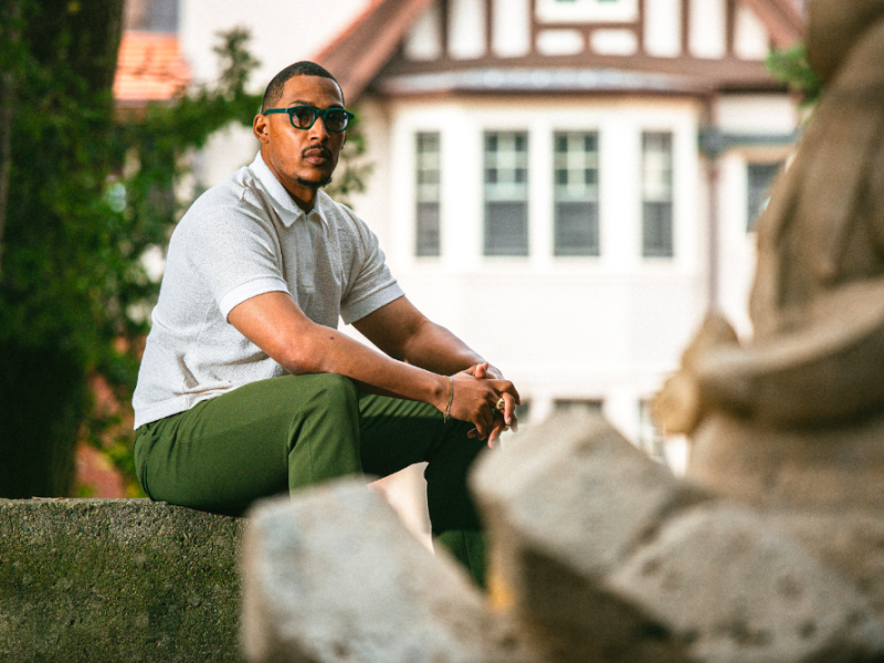 Steven Banks, known creatively as This Life. We Lead., poses confidently at Cranbrook House & Gardens in Bloomfield Hills on August 7, 2023.