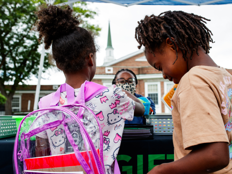 Attendants collect free school items from the Gift of Life Michigan table during the ‘Back to School Rally’ at Bethel United Methodist Church in Flint on Saturday, Sept. 9, 2023.