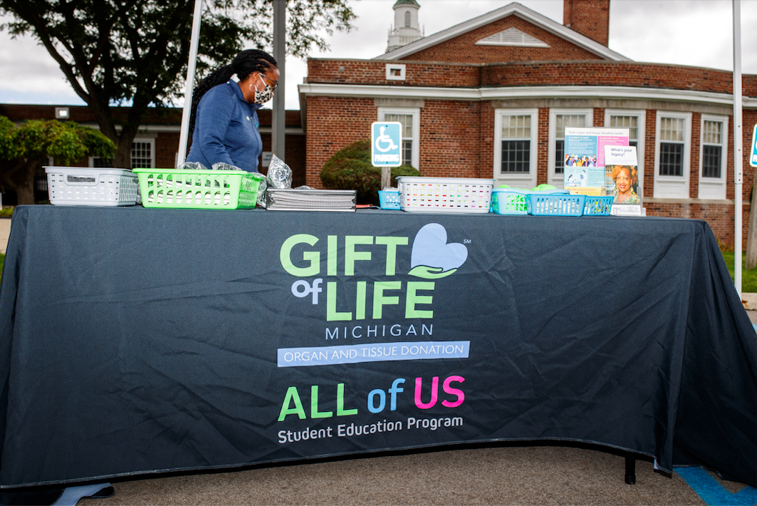 Shalonda Griffin prepares the Gift of Life Michigan tent which provided school supplies during the ‘Back to School Rally’ at Bethel United Methodist Church in Flint on Saturday, Sept. 9, 2023. (Jenifer Veloso | Flintside.com)