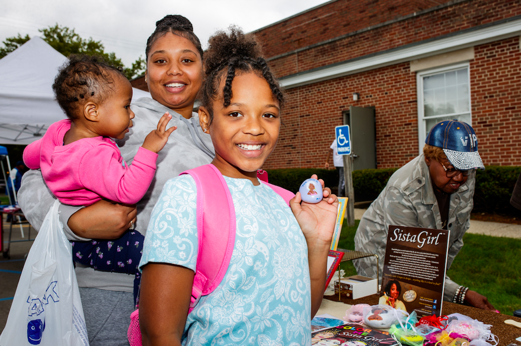 Zariyah poses with a handprinted stone from Sista Girl Greeting Cards that states, “You rock!’ during the ‘Back to School Rally’ at Bethel United Methodist Church in Flint on Saturday, Sept. 9, 2023. (Jenifer Veloso | Flintside.com)