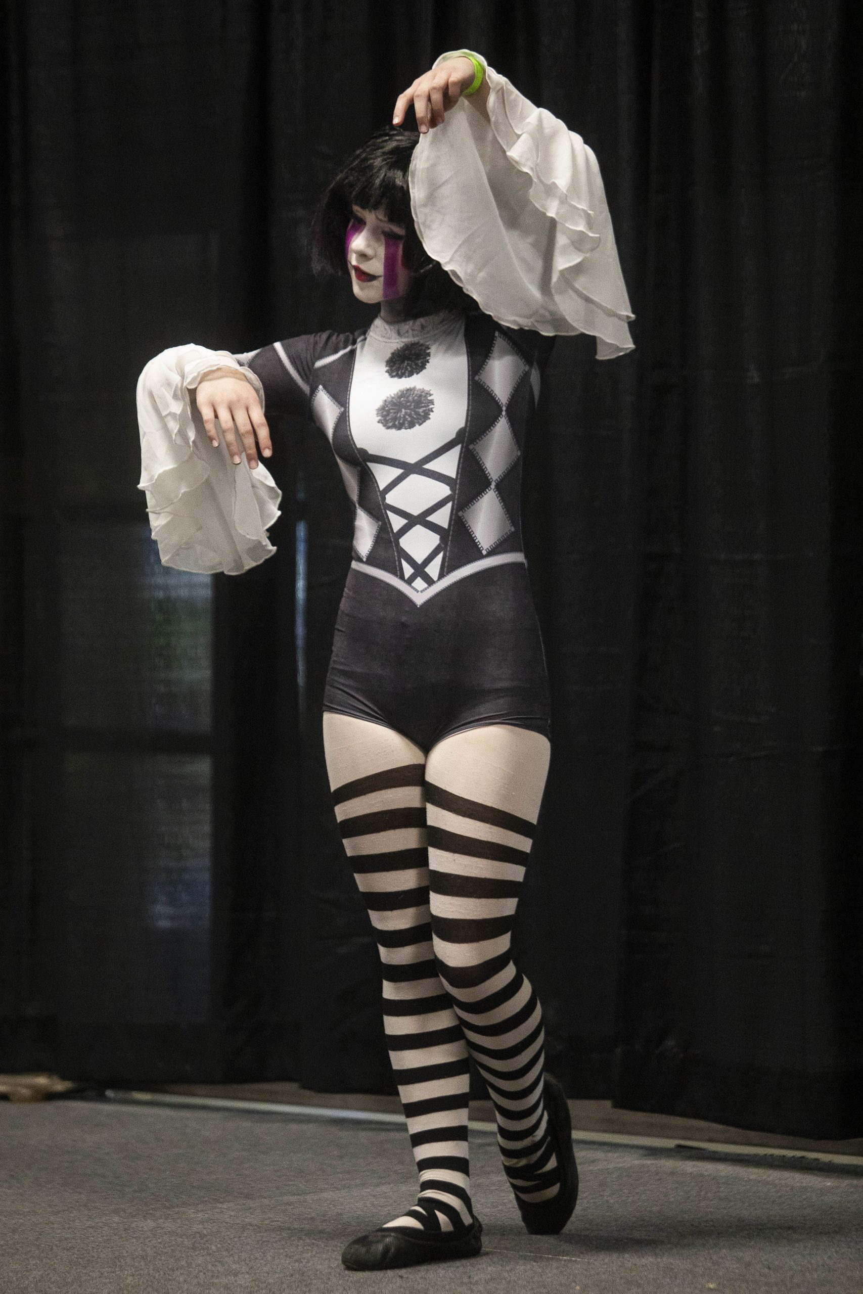 Aubrey Goodman, cosplaying as Puppet from “Five Nights at Freddy’s,” enters the stage as winners are announced for a cosplay contest during Really Cool Comic Con on Sunday, Aug. 6, 2023, at the Dort Financial Center in Flint.