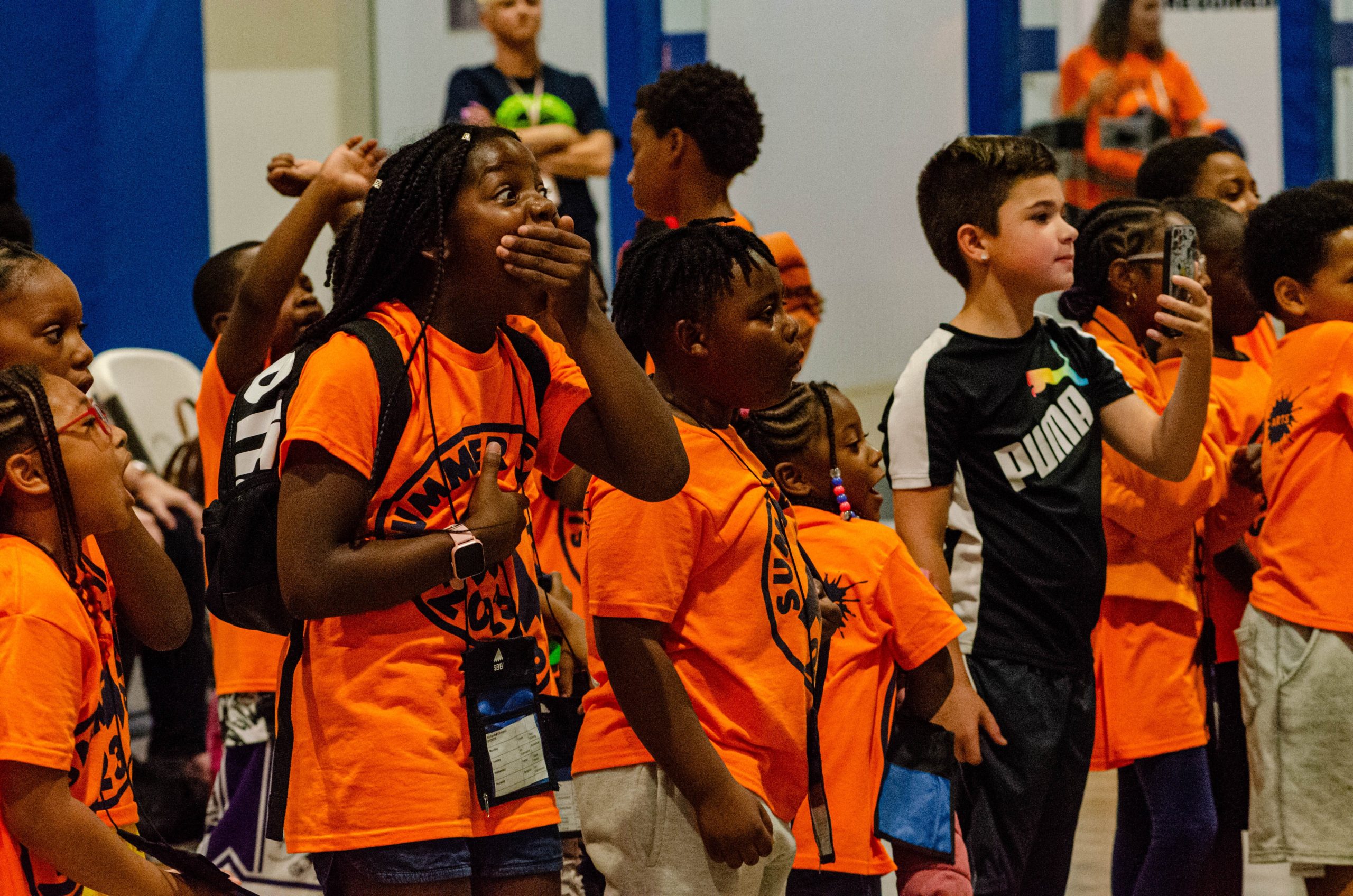 An excited group of kids enjoys a match at the 'Lockdown Pro Wrestling Fundraiser' at Sylvester Broome Empowerment Village on Thursday, July 13, 2023. (Rayford Gray | Flintside)