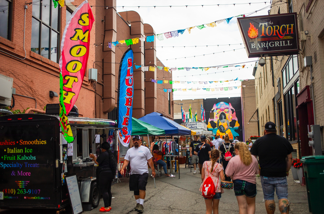 Hundreds of people gather in downtown Flint's Buckham Alley for Alley Fest on Saturday, July 8, 2023. (Katy Kildee | Flintside)
