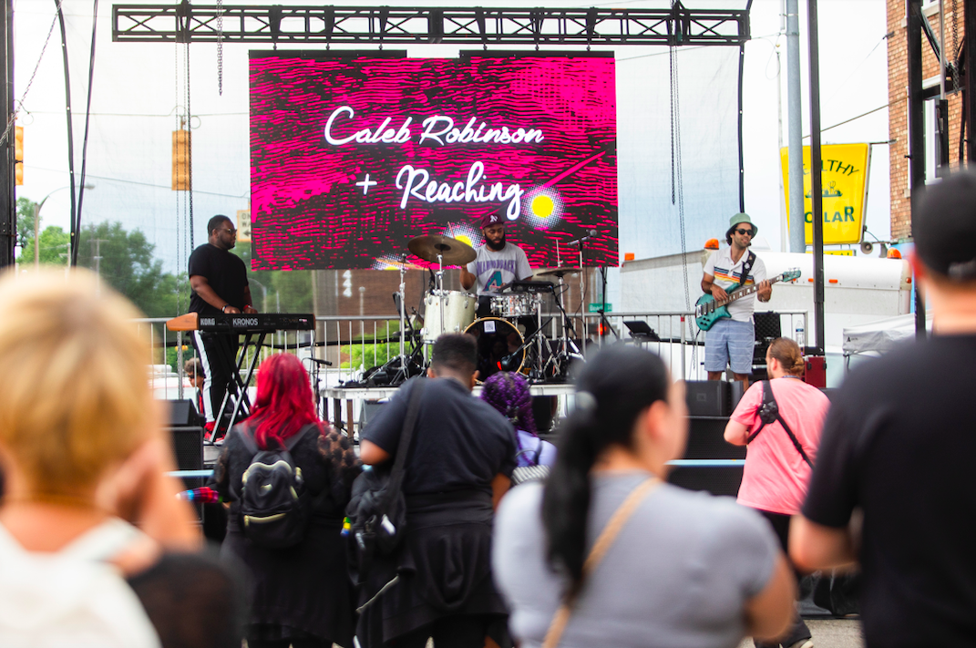 Caleb Robinson + Reaching perform as hundreds of people gather in downtown Flint's Buckham Alley for Alley Fest on Saturday, July 8, 2023. (Katy Kildee | Flintside)
