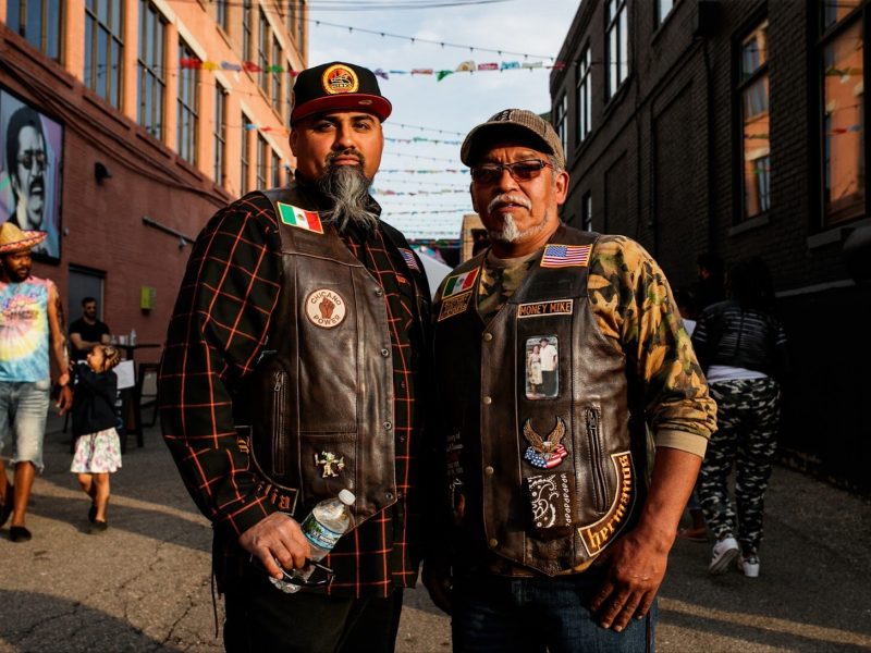 (Left to right) Tony and Cruz Asencio pose for a portrait during the Latinx Technology & Community Center’s Cinco de Mayo celebration on Friday, May 5, 2023, in Buckham Alley in downtown Flint.