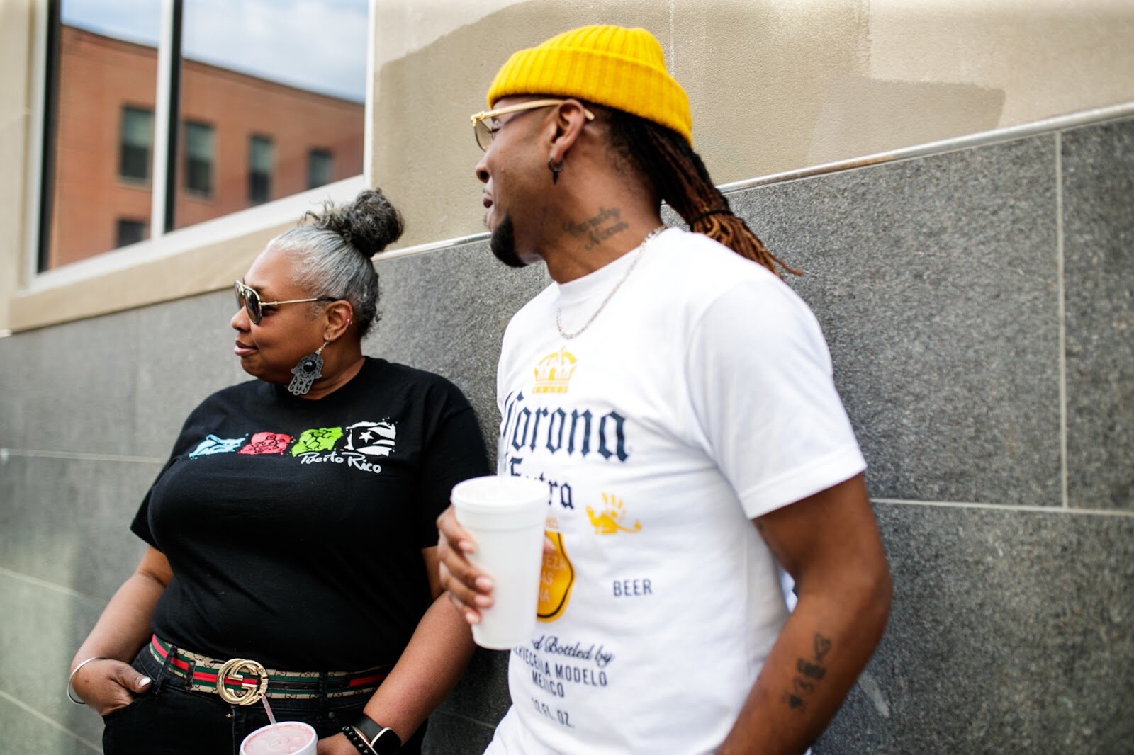 Two attendants watch people walk by during the Latinx Technology & Community Center’s Cinco de Mayo celebration on Friday, May 5, 2023, in Buckham Alley in downtown Flint. (Jenifer Veloso | Flintside)
