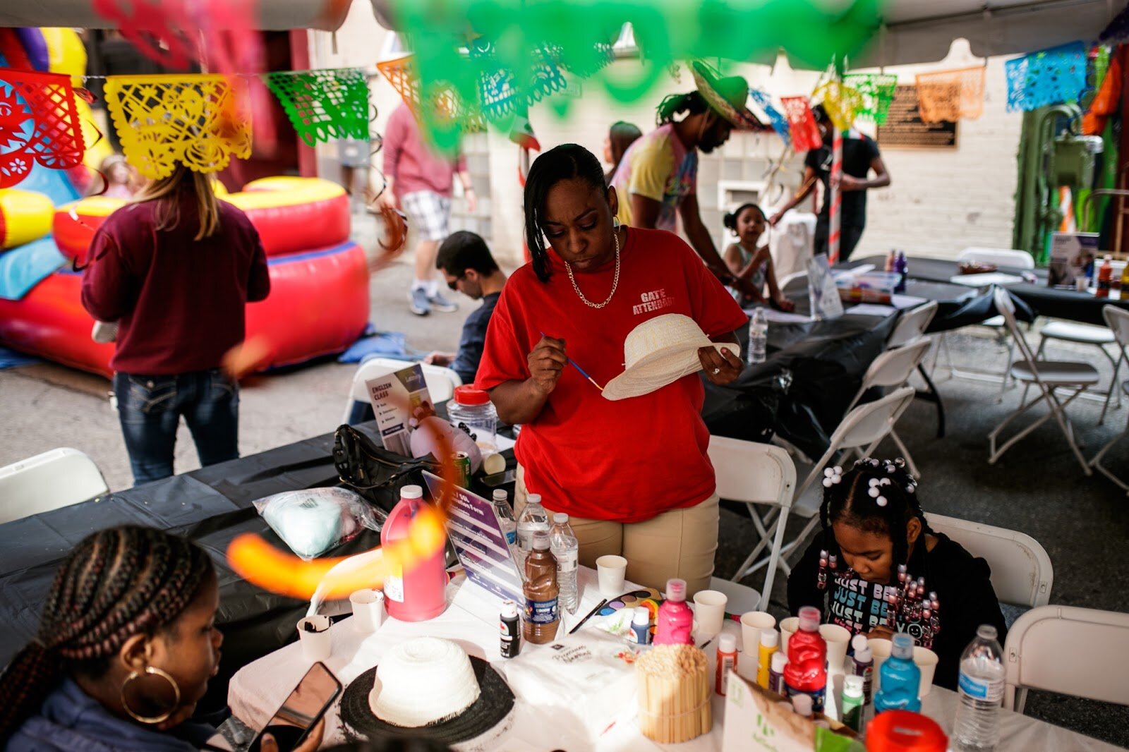 Attendants enjoy painting sombreros at the craft table during the Latinx Technology & Community Center’s Cinco de Mayo celebration on Friday, May 5, 2023, in Buckham Alley in downtown Flint. (Jenifer Veloso | Flintside)
