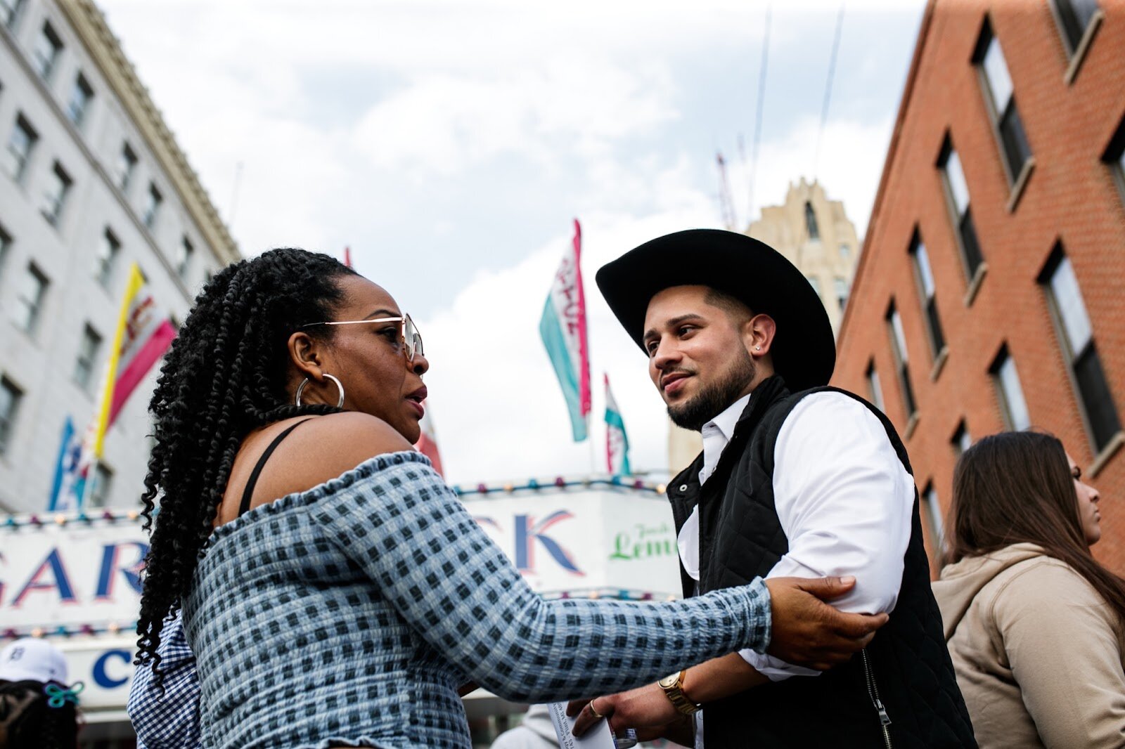 Latinx Center’s Executive Director Asa Zuccaro talks with another guest during the Latinx Technology & Community Center’s Cinco de Mayo celebration on Friday, May 5, 2023, in Buckham Alley in downtown Flint. (Jenifer Veloso | Flintside)
